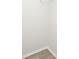 Corner view of a room with light wood flooring, white walls, and trim along the baseboard and ceiling at 10263 Gandy N Blvd # 105, St Petersburg, FL 33702