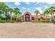 Exterior view of a clubhouse with tropical landscaping and brick parking at 10263 Gandy N Blvd # 105, St Petersburg, FL 33702