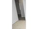 Hallway with tan tiles in foreground transitioning to wood-look floors in the distance at 10263 Gandy N Blvd # 105, St Petersburg, FL 33702