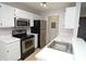 Bright kitchen featuring stainless steel appliances, white cabinets, and a stainless steel sink at 10263 Gandy N Blvd # 105, St Petersburg, FL 33702