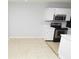 Clean kitchen with stainless steel appliances, white cabinets, and light tan tile flooring at 10263 Gandy N Blvd # 105, St Petersburg, FL 33702