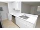Kitchen with white cabinets, stainless steel dishwasher, a stainless steel sink and a breakfast bar at 10263 Gandy N Blvd # 105, St Petersburg, FL 33702