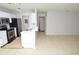 Open kitchen with stainless steel appliances, breakfast bar, and tile flooring flowing into the living area at 10263 Gandy N Blvd # 105, St Petersburg, FL 33702