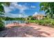 Scenic patio offering serene lake views, complemented by comfortable seating and lush landscaping at 10263 Gandy N Blvd # 105, St Petersburg, FL 33702
