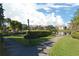 Scenic view of a pond surrounded by lush landscaping, condos, and walkways at 10263 Gandy N Blvd # 105, St Petersburg, FL 33702