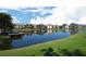 Panoramic view of a calm pond reflecting the sky and surrounding condominiums at 10263 Gandy N Blvd # 105, St Petersburg, FL 33702