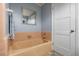 Bathroom featuring a classic bathtub and fixtures with colorful tile flooring at 1036 N Shore Ne Dr # 5, St Petersburg, FL 33701