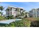 A condo building features a modern design and lush tropical landscaping at 1036 N Shore Ne Dr # 5, St Petersburg, FL 33701