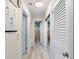Bright hallway with light wood floors leads to bath with decorative tile and ample storage at 1036 N Shore Ne Dr # 5, St Petersburg, FL 33701