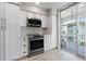Modern kitchen featuring white cabinetry, stainless steel appliances, and natural light at 1036 N Shore Ne Dr # 5, St Petersburg, FL 33701