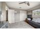 This bedroom features light grey walls, a ceiling fan, and closet at 10635 Huston Ln, Largo, FL 33774