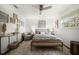 Neutral bedroom features a bed, sitting chair, stylish decor, and a large window offering natural light at 10635 Huston Ln, Largo, FL 33774