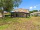 Spacious backyard view featuring a large screened patio and grassy lawn at 10904 Summerton Dr, Riverview, FL 33579