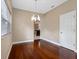 A dining room with hardwood floors, a window, and a view of the kitchen at 10904 Summerton Dr, Riverview, FL 33579