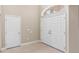 Spacious foyer featuring neutral walls, tiled flooring, and a double-door entry with transom window above at 10904 Summerton Dr, Riverview, FL 33579
