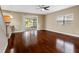 A living room featuring hardwood floors, a sliding glass door to the lanai, and a window at 10904 Summerton Dr, Riverview, FL 33579