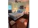 Comfortable bedroom with a queen bed, ceiling fan, side tables with lamps, and a window with blinds at 11100 86Th Ave # 203, Seminole, FL 33772