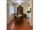 Well-lit dining room with wood floors, a dining table set for four, and a hutch at 11100 86Th Ave # 203, Seminole, FL 33772