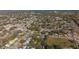 Neighborhood aerial view showcasing lush tree coverage and proximity to nearby waterways at 1125 Fairwood Ave, Clearwater, FL 33759