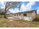 Backyard featuring a privacy fence, brick patio, mature trees, and lots of space at 1125 Fairwood Ave, Clearwater, FL 33759