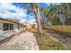 Large backyard featuring a new wooden fence, mature trees, and a brick paver patio at 1125 Fairwood Ave, Clearwater, FL 33759