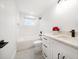 Bright bathroom with white cabinets, black hardware, and subway tile surrounding the tub at 1125 Fairwood Ave, Clearwater, FL 33759
