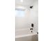 Bright bathroom featuring tiled shower over tub with matte black fixtures at 1125 Fairwood Ave, Clearwater, FL 33759