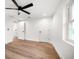 Bedroom featuring a ceiling fan, wood floors, and a walk-in closet at 1125 Fairwood Ave, Clearwater, FL 33759