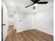 Bedroom featuring wood floors, a ceiling fan, and closet space at 1125 Fairwood Ave, Clearwater, FL 33759
