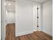Bedroom with wood flooring and access to additional rooms at 1125 Fairwood Ave, Clearwater, FL 33759