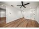 Bedroom with wood flooring, white trim and a black ceiling fan at 1125 Fairwood Ave, Clearwater, FL 33759