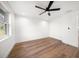 Bedroom with wood floors, white walls, a ceiling fan, and a bright window at 1125 Fairwood Ave, Clearwater, FL 33759