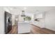 Bright kitchen featuring stainless steel appliances, white cabinetry, and a large center island with marble countertops at 1125 Fairwood Ave, Clearwater, FL 33759