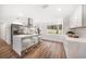 Bright kitchen featuring stainless steel appliances, white cabinetry, and a large center island with seating at 1125 Fairwood Ave, Clearwater, FL 33759