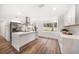 Bright kitchen featuring stainless steel appliances, white cabinetry, and a large center island with marble countertops at 1125 Fairwood Ave, Clearwater, FL 33759
