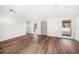 Spacious empty living room with hardwood flooring, neutral paint, and natural light perfect for customization at 1125 Fairwood Ave, Clearwater, FL 33759