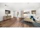 Living room featuring hardwood flooring, a comfortable couch, and natural light from the large windows at 1125 Fairwood Ave, Clearwater, FL 33759