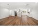 Open floor plan with updated hardwood flooring and bright white walls leading into the kitchen at 1125 Fairwood Ave, Clearwater, FL 33759