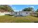 Large backyard featuring a lush lawn and a view of the home's rear exterior at 1140 7Th Ne Ave, Largo, FL 33770