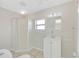 Bright bathroom with a shower and a tiled wall behind the sink at 1140 7Th Ne Ave, Largo, FL 33770