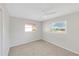 Inviting bedroom with neutral walls, carpeted floors, and windows allowing natural light, creating a cozy atmosphere at 1140 7Th Ne Ave, Largo, FL 33770