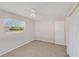 Cozy bedroom featuring neutral walls, carpeted floors, a ceiling fan, and a window to brighten the space at 1140 7Th Ne Ave, Largo, FL 33770