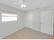 Bright bedroom with carpeted floors, neutral walls, a ceiling fan, a window, and a closet at 1140 7Th Ne Ave, Largo, FL 33770