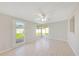 Versatile bonus room bathed in sunlight from multiple windows and an outdoor door at 1140 7Th Ne Ave, Largo, FL 33770