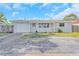 Charming single-story home with a well-maintained front yard and attached garage at 1140 7Th Ne Ave, Largo, FL 33770