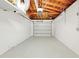 Spacious garage with an exposed ceiling, a cement floor, and a garage door at 1140 7Th Ne Ave, Largo, FL 33770