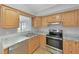 Stylish kitchen with granite countertops, stainless steel appliances and open window at 1140 7Th Ne Ave, Largo, FL 33770
