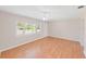 Sun-filled living room featuring hardwood floors, and a large front window at 1140 7Th Ne Ave, Largo, FL 33770