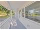 Inviting covered porch offers a charming outdoor seating area with view of neighborhood at 1140 7Th Ne Ave, Largo, FL 33770