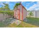 Backyard shed with a charming vine detail and ample storage space at 1140 7Th Ne Ave, Largo, FL 33770